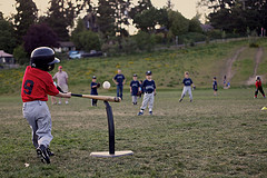 tee ball batting taking a good cut.