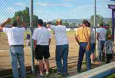 baseball dads at backstop over coaching youth players