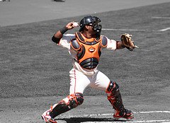 pro catcher in the bow and arrow throwing position working the 1st and 3rd defense