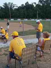 baseball parents intensely following the baseball game