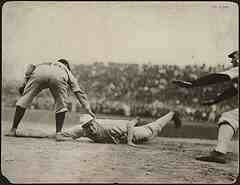 old school runner diving back to first base on pick off throw